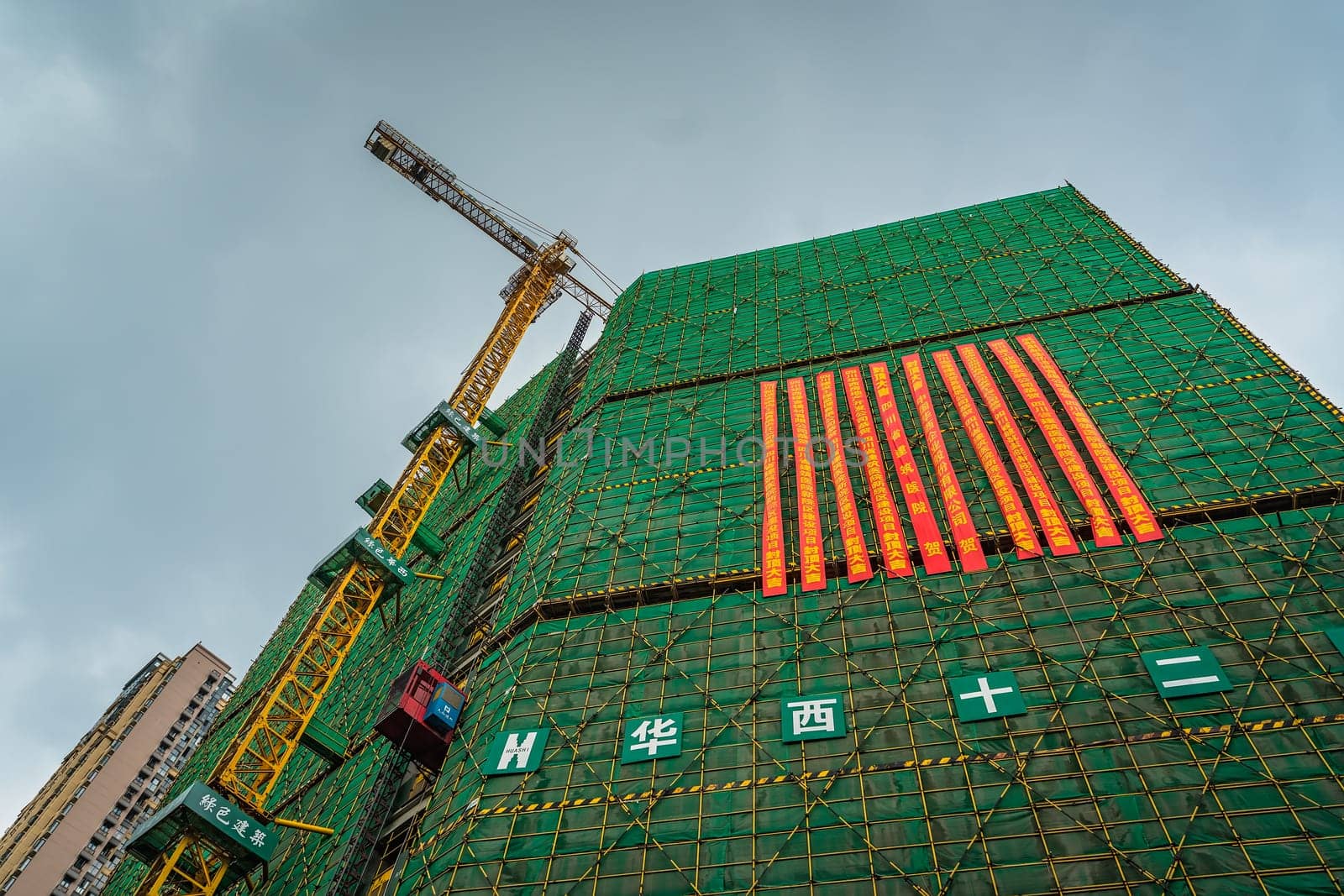 Chengdu, China -  July 2019 : Cranes on the building site of brand new high rise living apartments in the centre of town, Sichuan Province