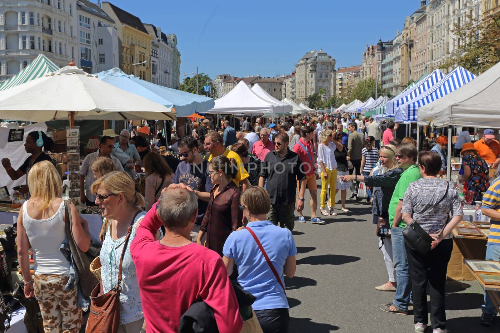Vienna, Austria - July 11, 2015: People Shopping at Naschmarkt Flea Market Saturday Summer in Vienna, Austria.