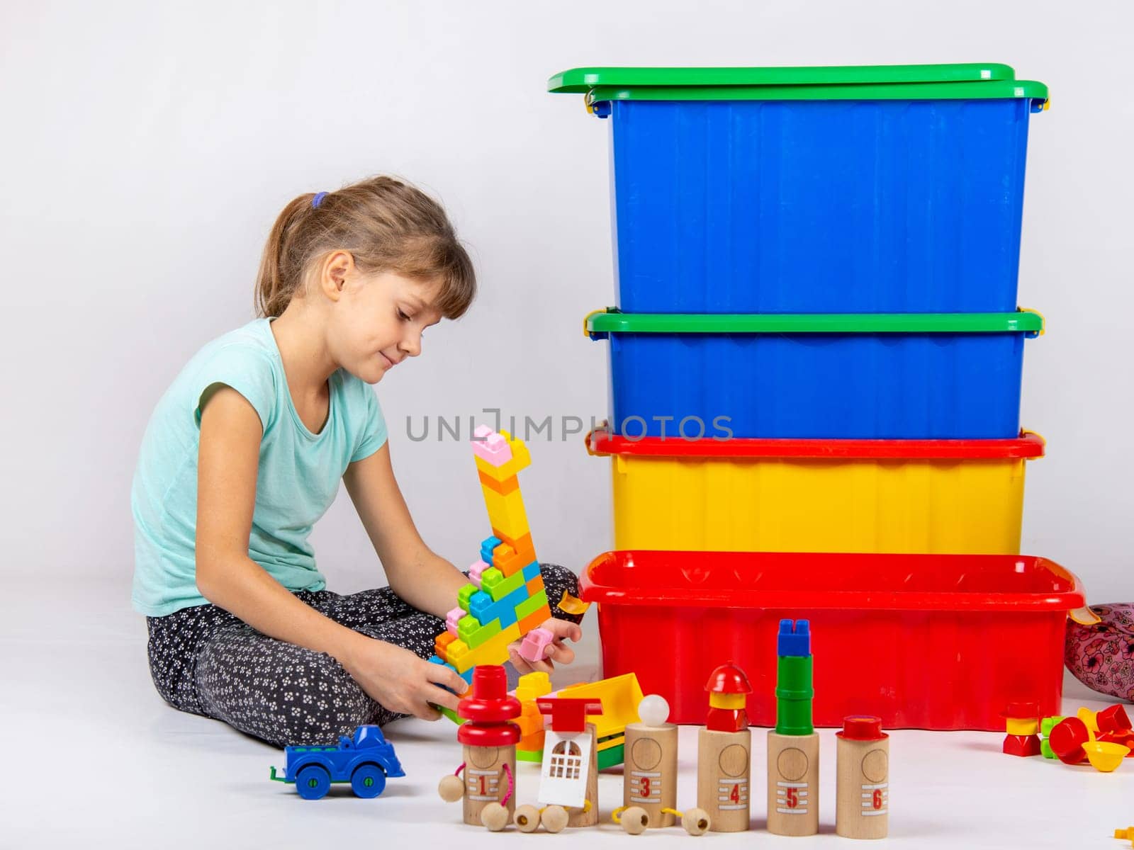 Girl alone plays toys