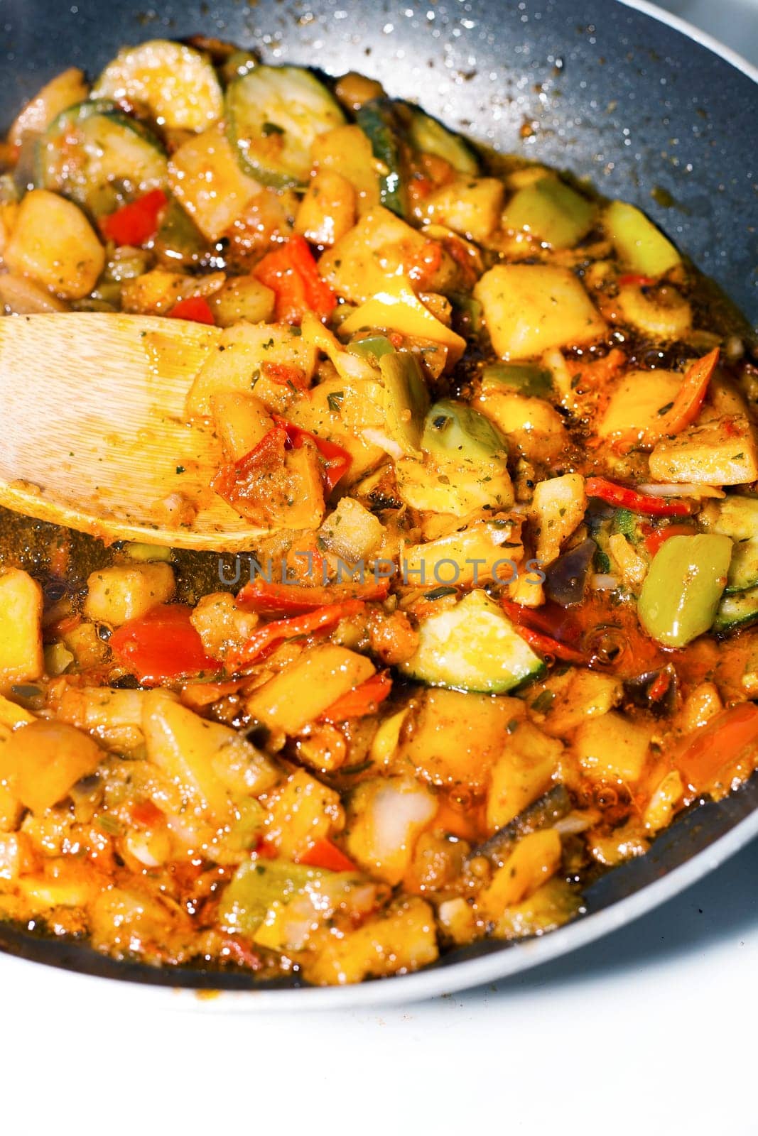 Ratatouille is a French Provencal stewed vegetable dish, originating in Nice. Recipe ingredients include tomato, garlic, onion, zucchini, aubergine (eggplant), bell pepper, and some combination of leafy green herbs common to the region.