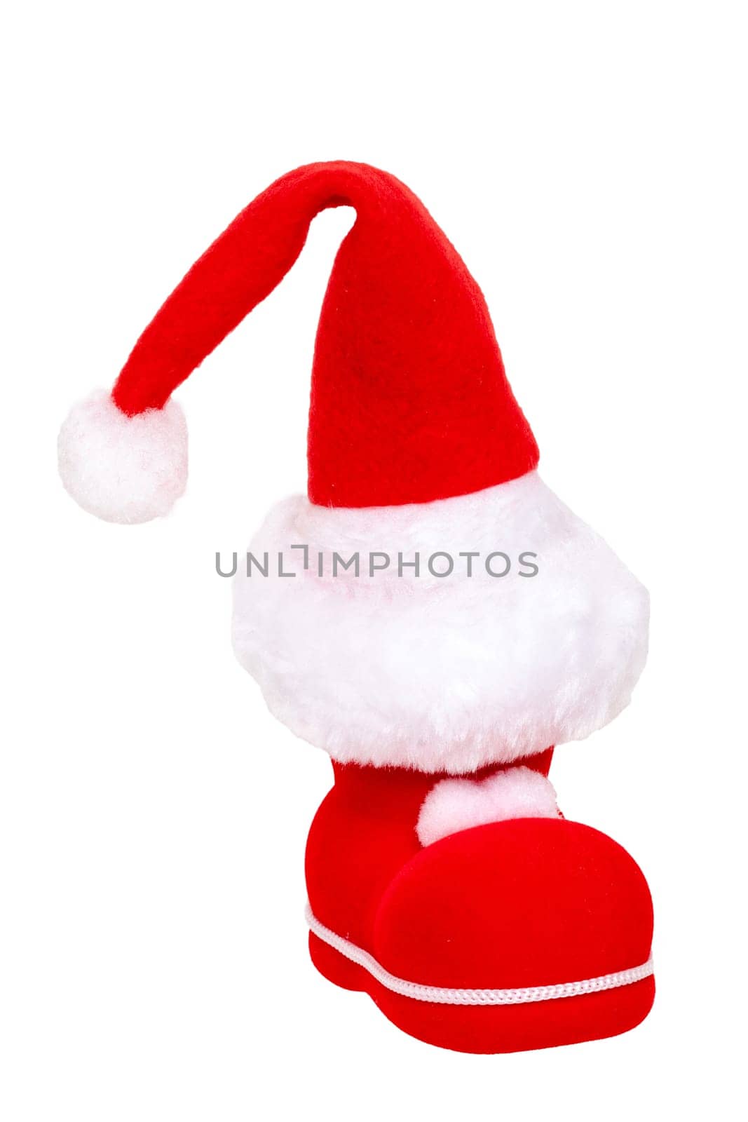 Christmas decorations isolated. Close-up of a red Santa Claus boot with a santa claus hat on it isolated on a white background. Beautiful Christmas design element. Macro.