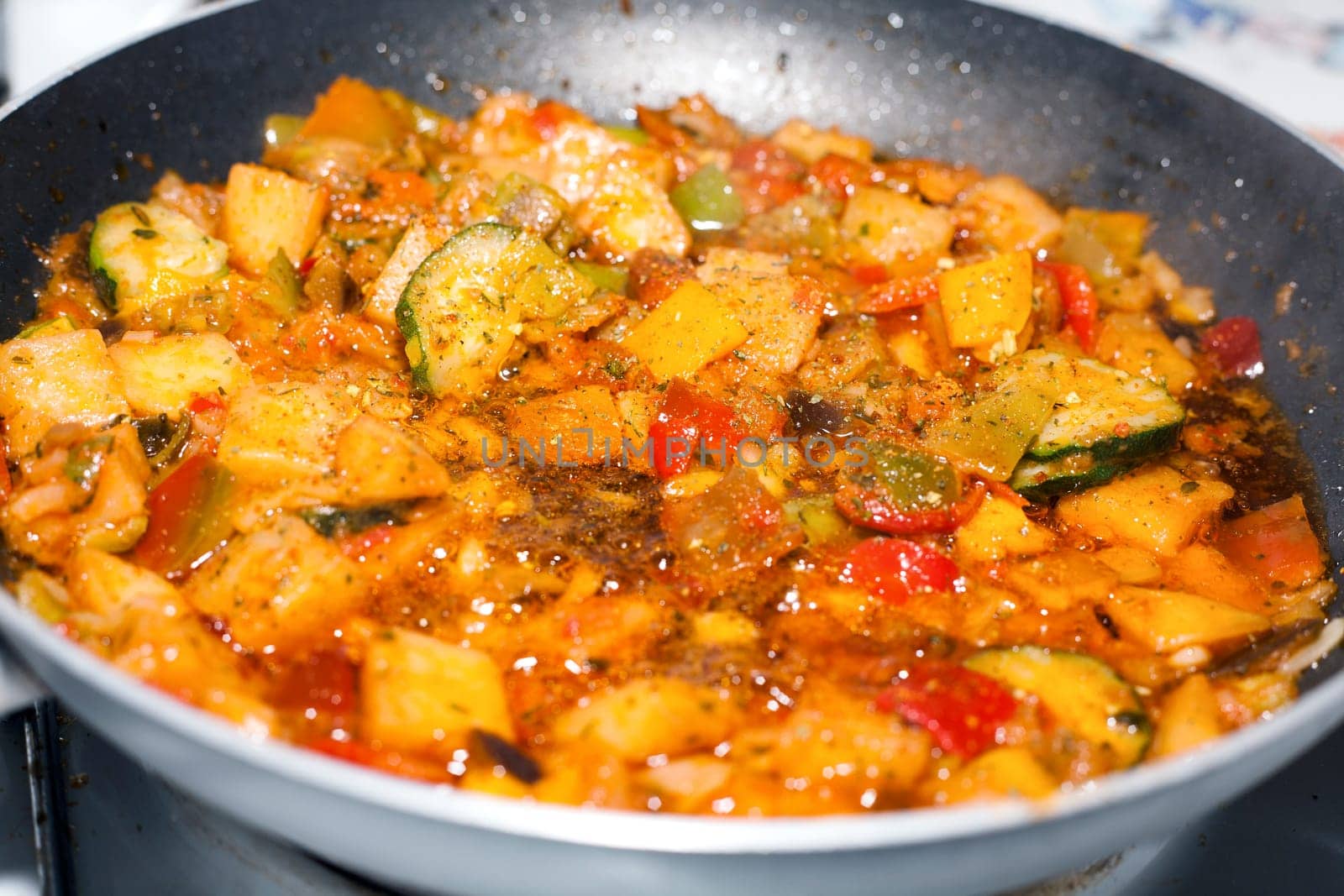 Ratatouille is a French Provencal stewed vegetable dish, originating in Nice. Recipe ingredients include tomato, garlic, onion, zucchini, aubergine (eggplant), bell pepper, and some combination of leafy green herbs common to the region.