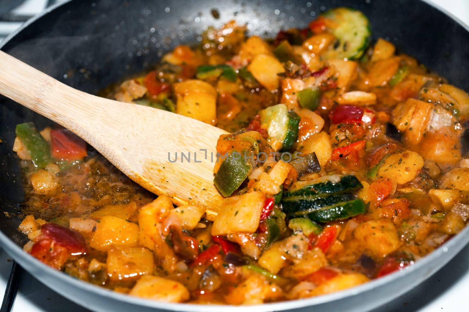 Ratatouille is a French Provencal stewed vegetable dish, originating in Nice. Recipe ingredients include tomato, garlic, onion, zucchini, aubergine (eggplant), bell pepper, and some combination of leafy green herbs common to the region.