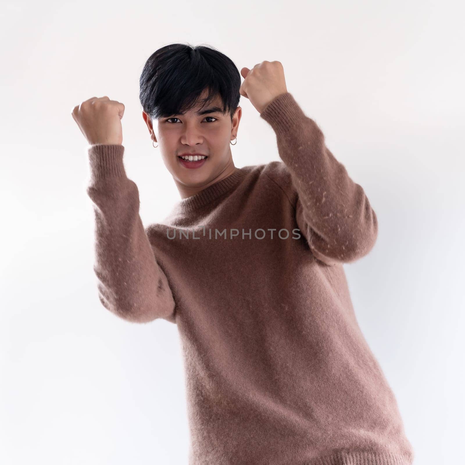 Portrait of good-looking smart Teenager young asian adult boy wearing brown sweater for winter on white background