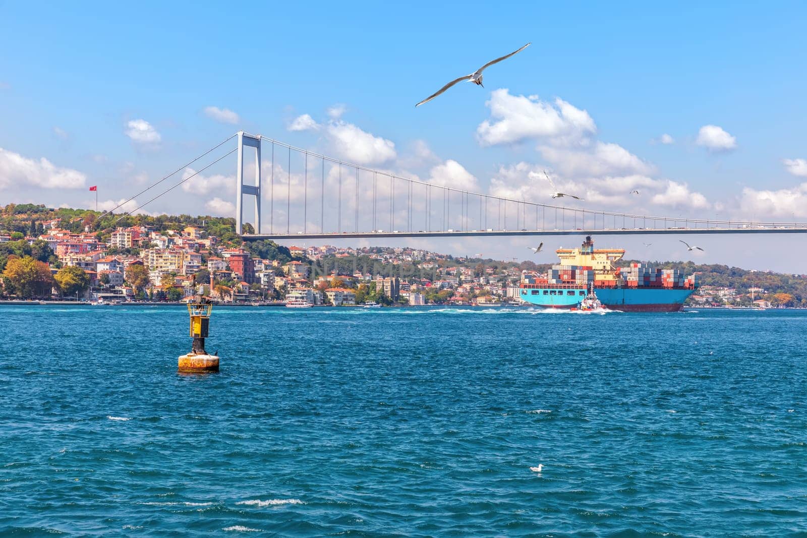 The Fatih Sultan Mehmet Bridge, the cargo ship and the Bosphorus view, Istanbul.