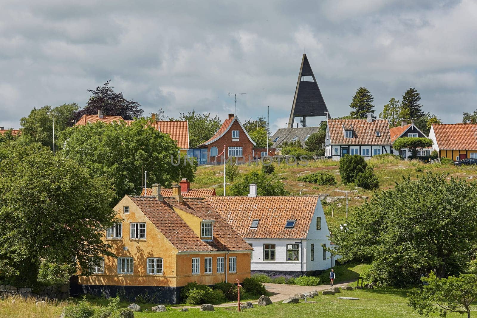 SVANEKE, DENMARK - JULY 4, 2017: View of village of Svaneke in Denmark and modern three-legged water tower designed by Jorn Utzonon.