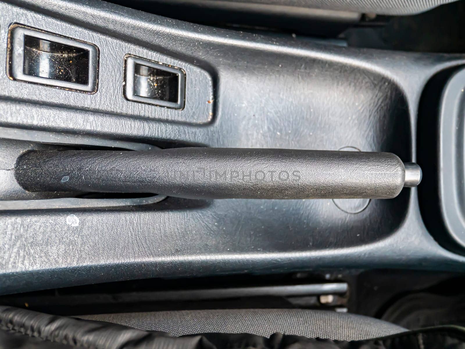 The lever of a manual brake of the car. Place for text. Transport.