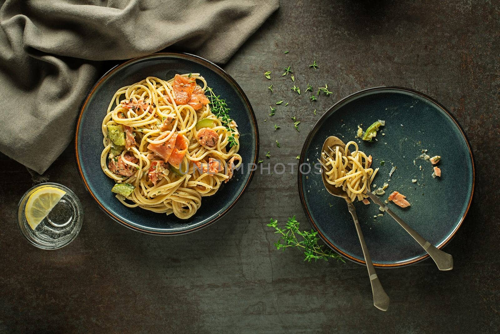 Eating fresh pasta with smoked salmon in cream sauce. Healthy vegetarian meal