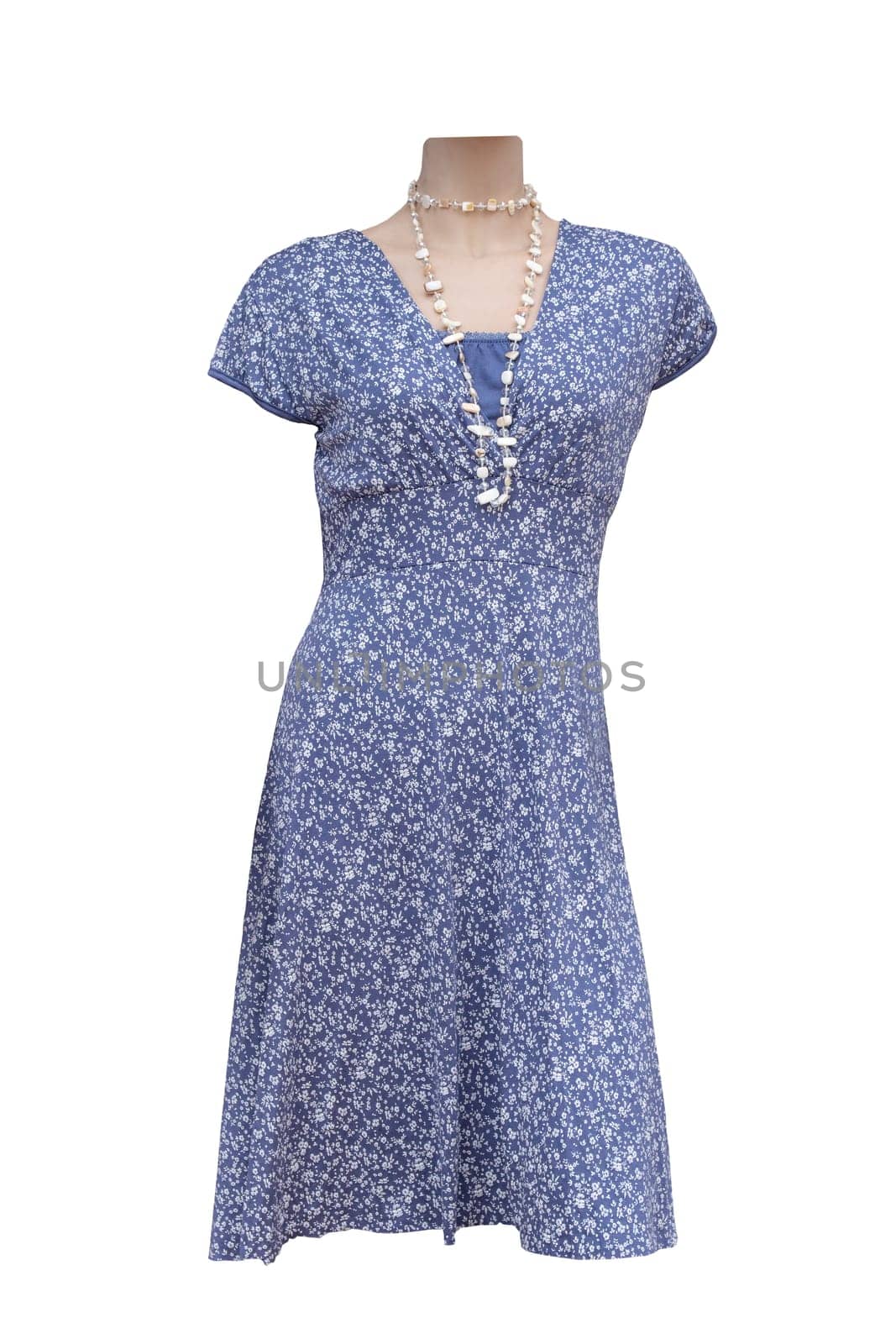 Dress isolated. Closeup of colorful blue white elegant stylish sleeveless summer dress on mannequin isolated on a white background. Summer fashion.