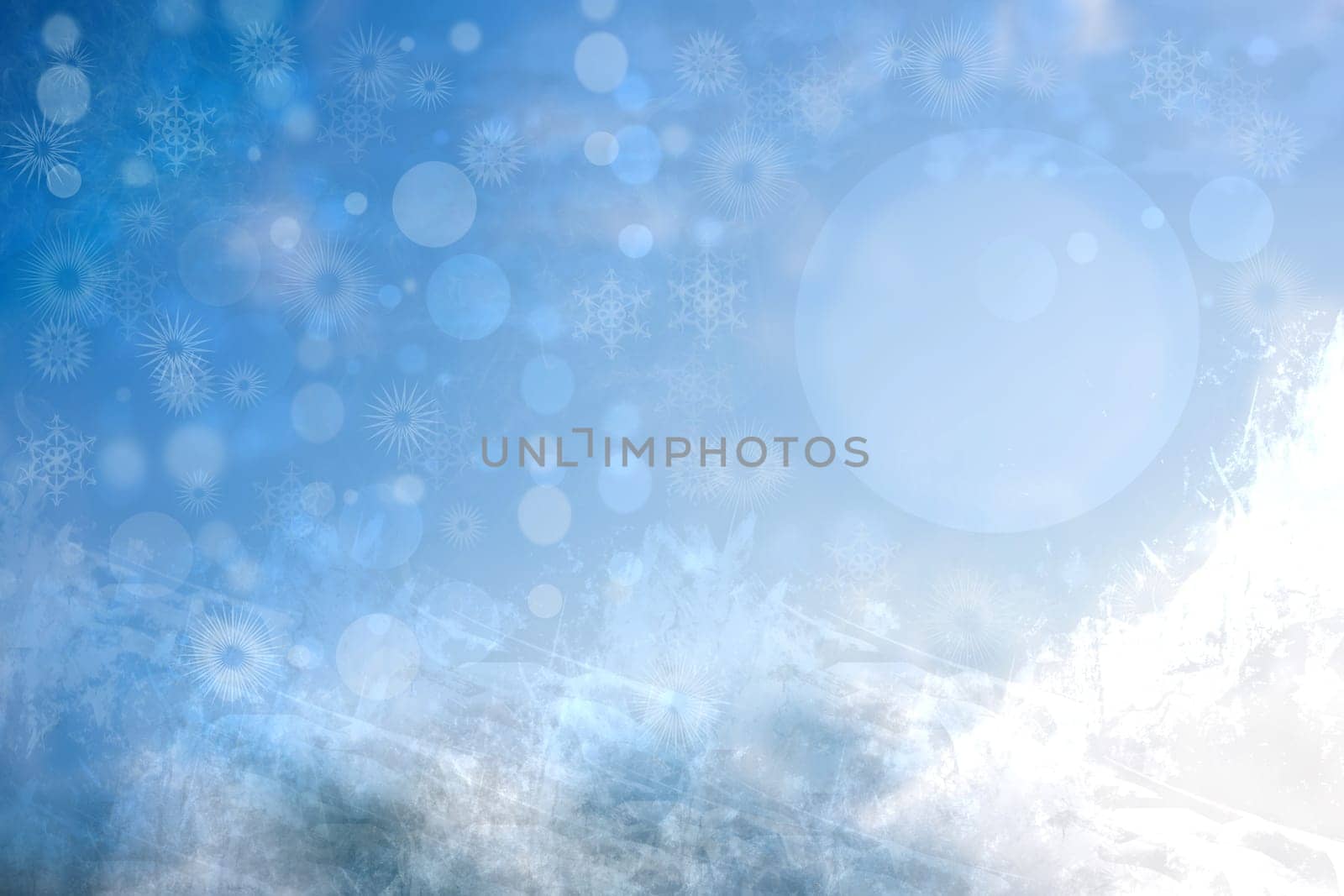 Abstract blurred festive winter christmas background with shiny blue and white bokeh lighted snow mountains landscape with stars and a blue sky.