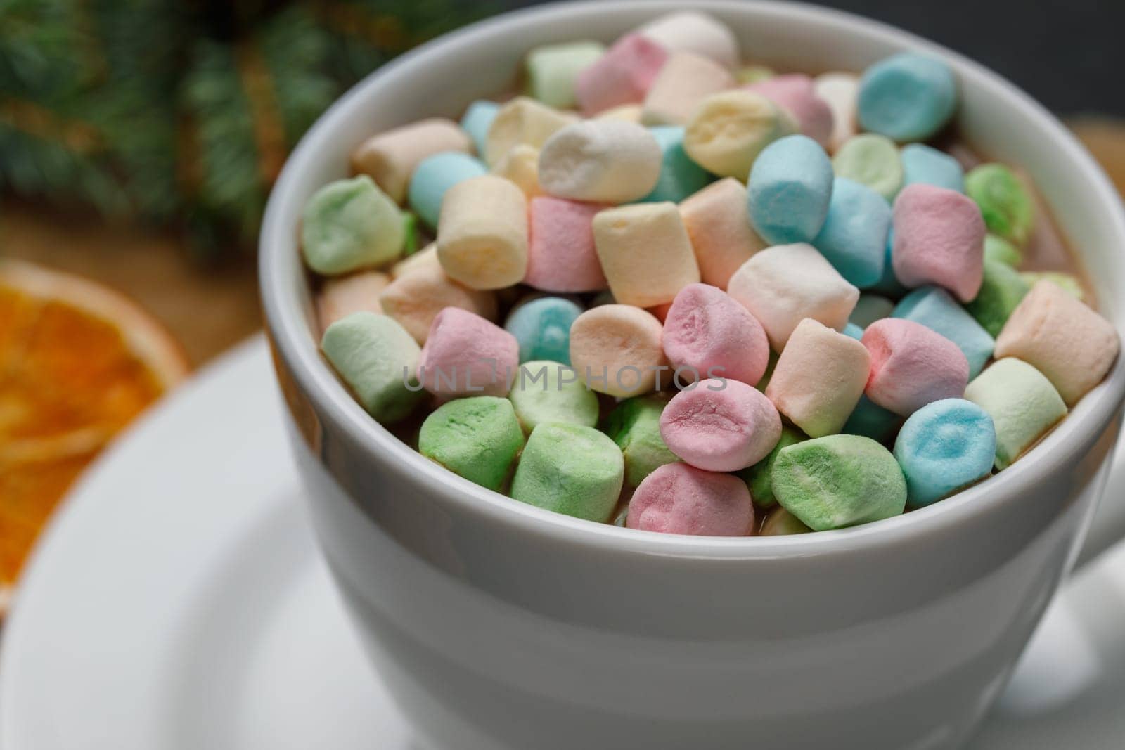 Marshmello with cocoa in a mug on a surface of different colors