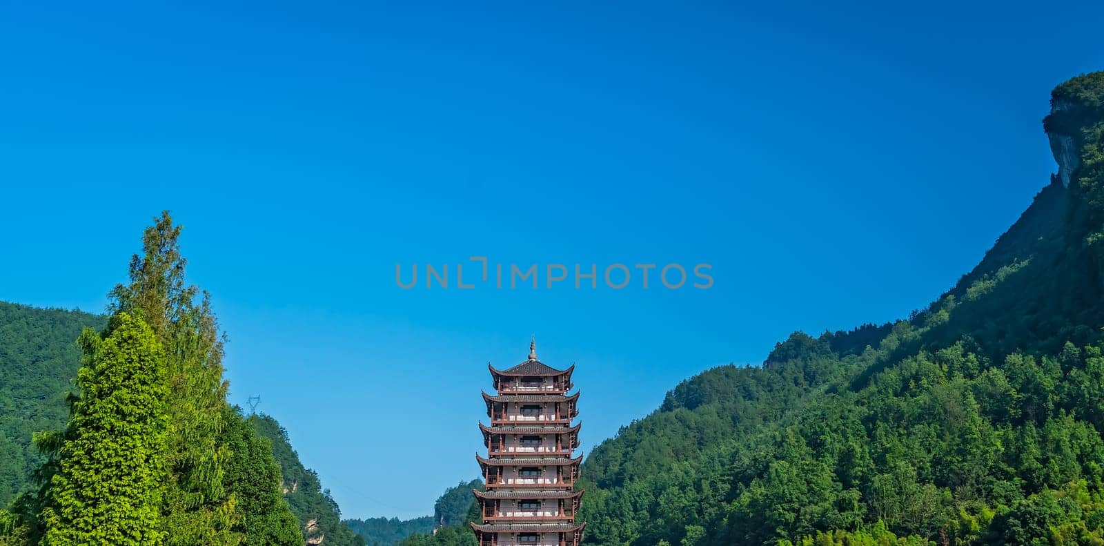 Traditional chinese style wooden tower pagoda standing at the Wulingyuan entrance to the Zhangjiajie national park, Hunan Province, China