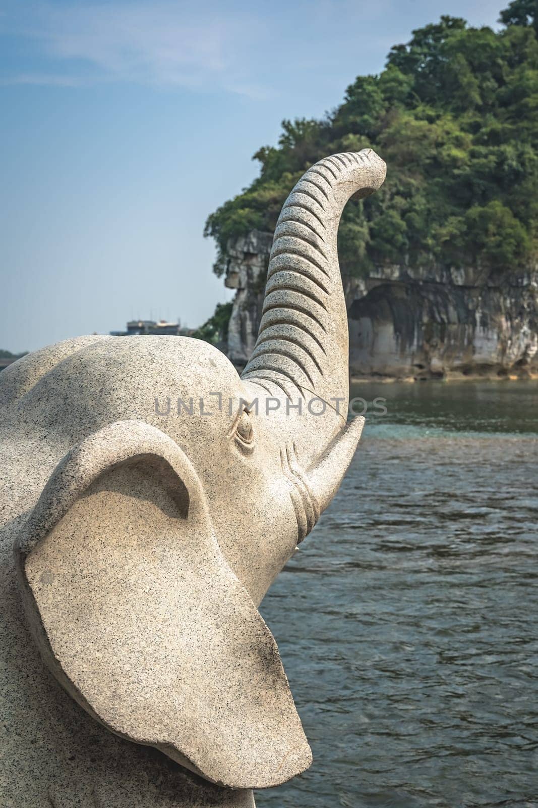Large marble elephant statue next to the landmark Elephant Trunk Hill Arch and the Li River Lijiang River in Guilin, Guangxi Province, China