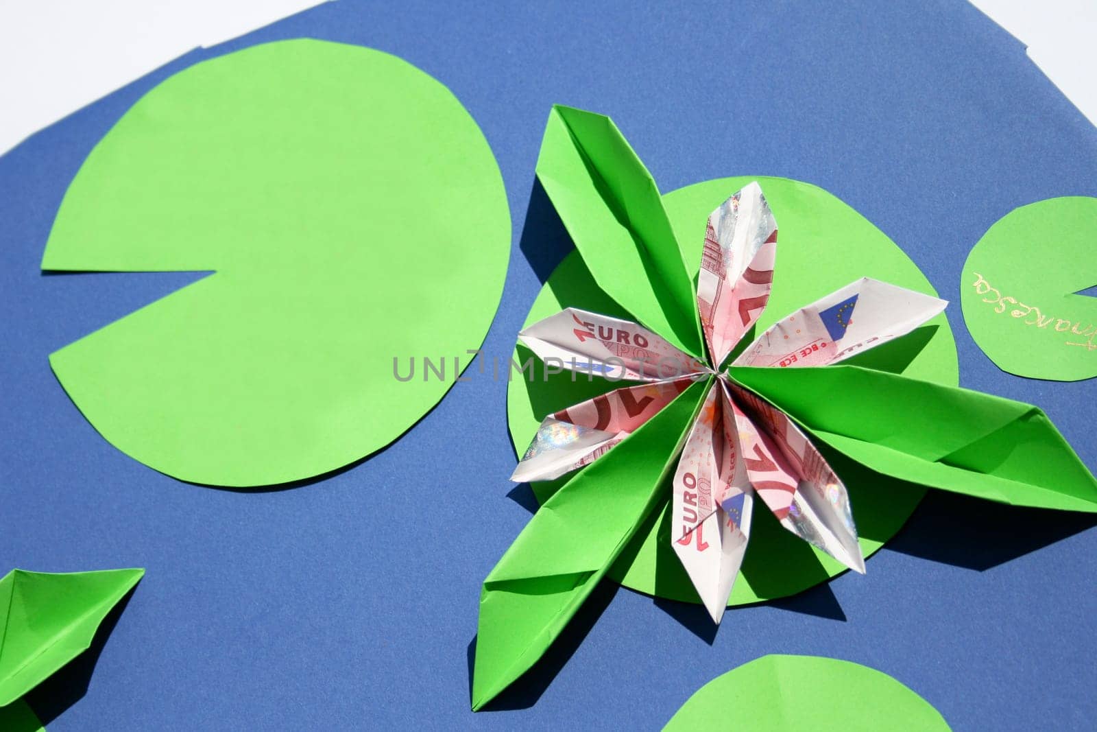 a water lily with leaves and water fashioned from paper