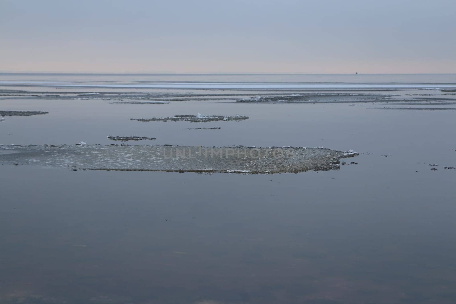 lake freezes is covered with thin ice, a winter landscape
