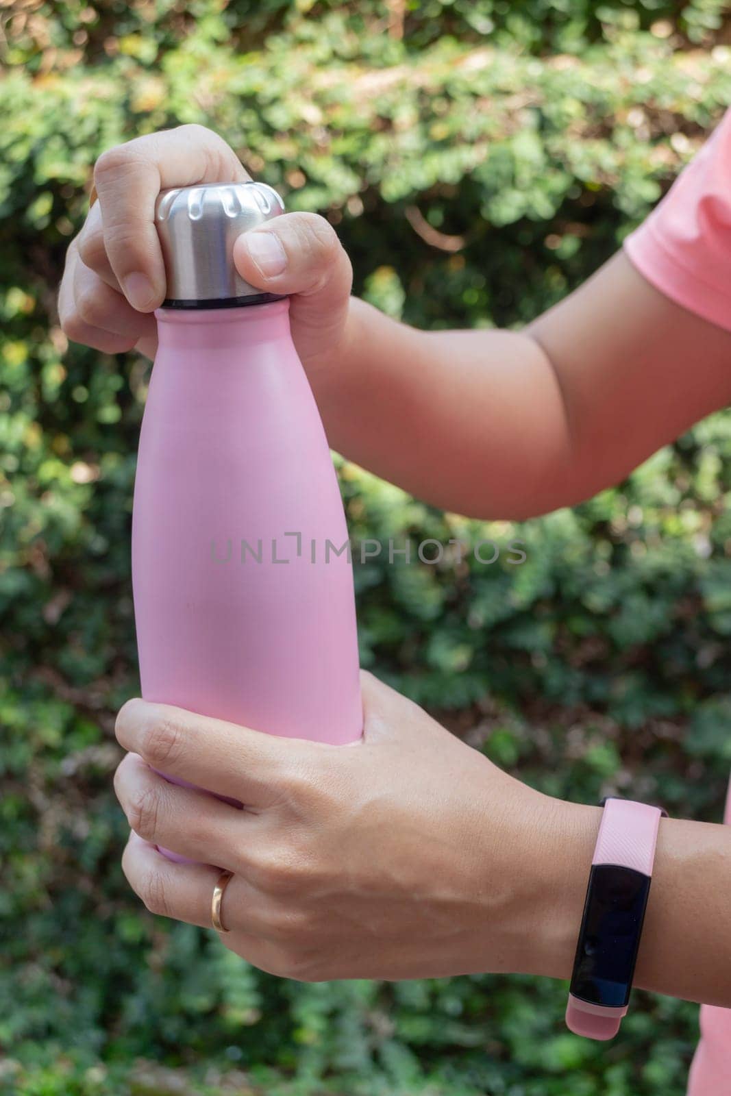 Hand on water bottle for keep temperature, stock photo