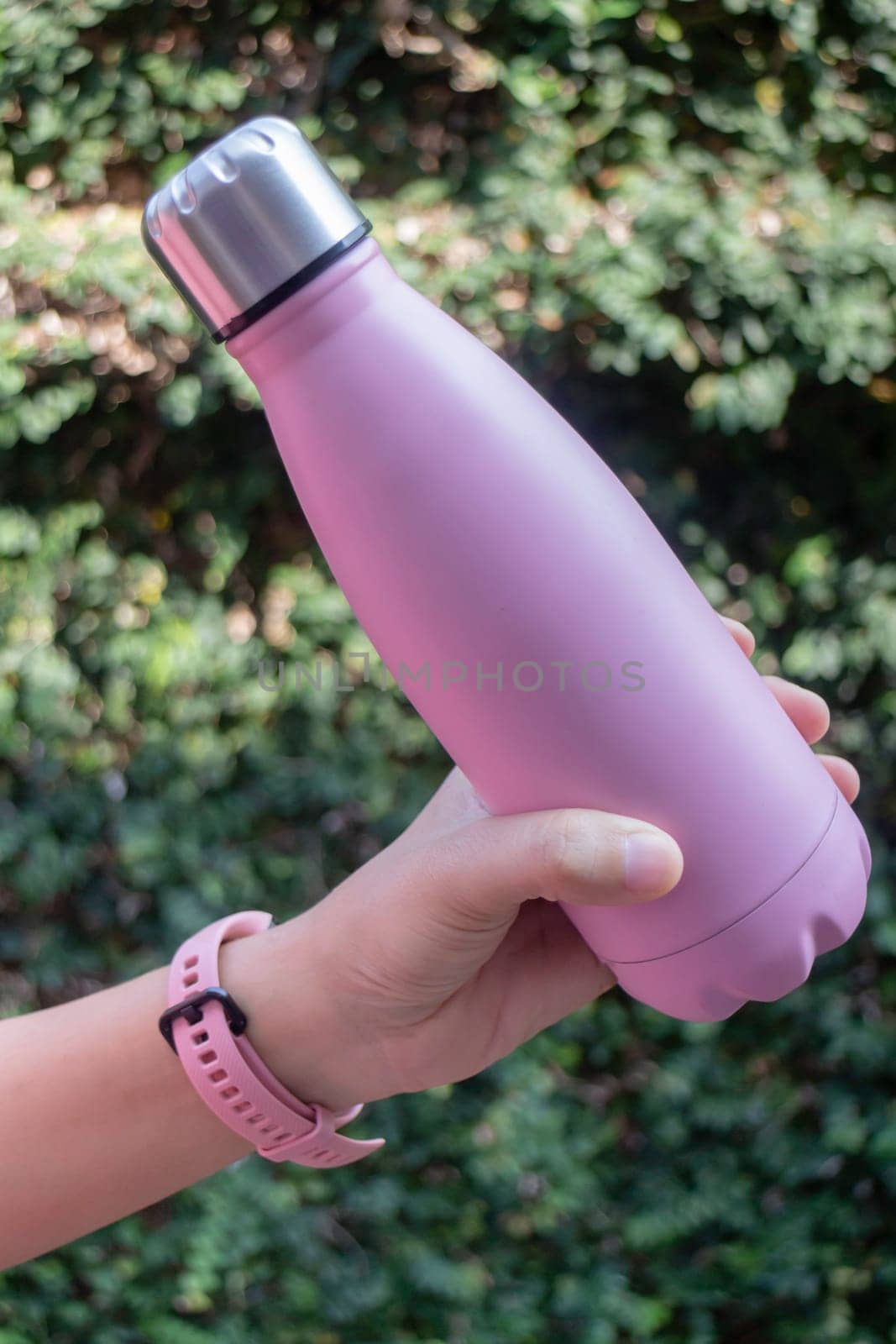 Hand on water bottle for keep temperature, stock photo