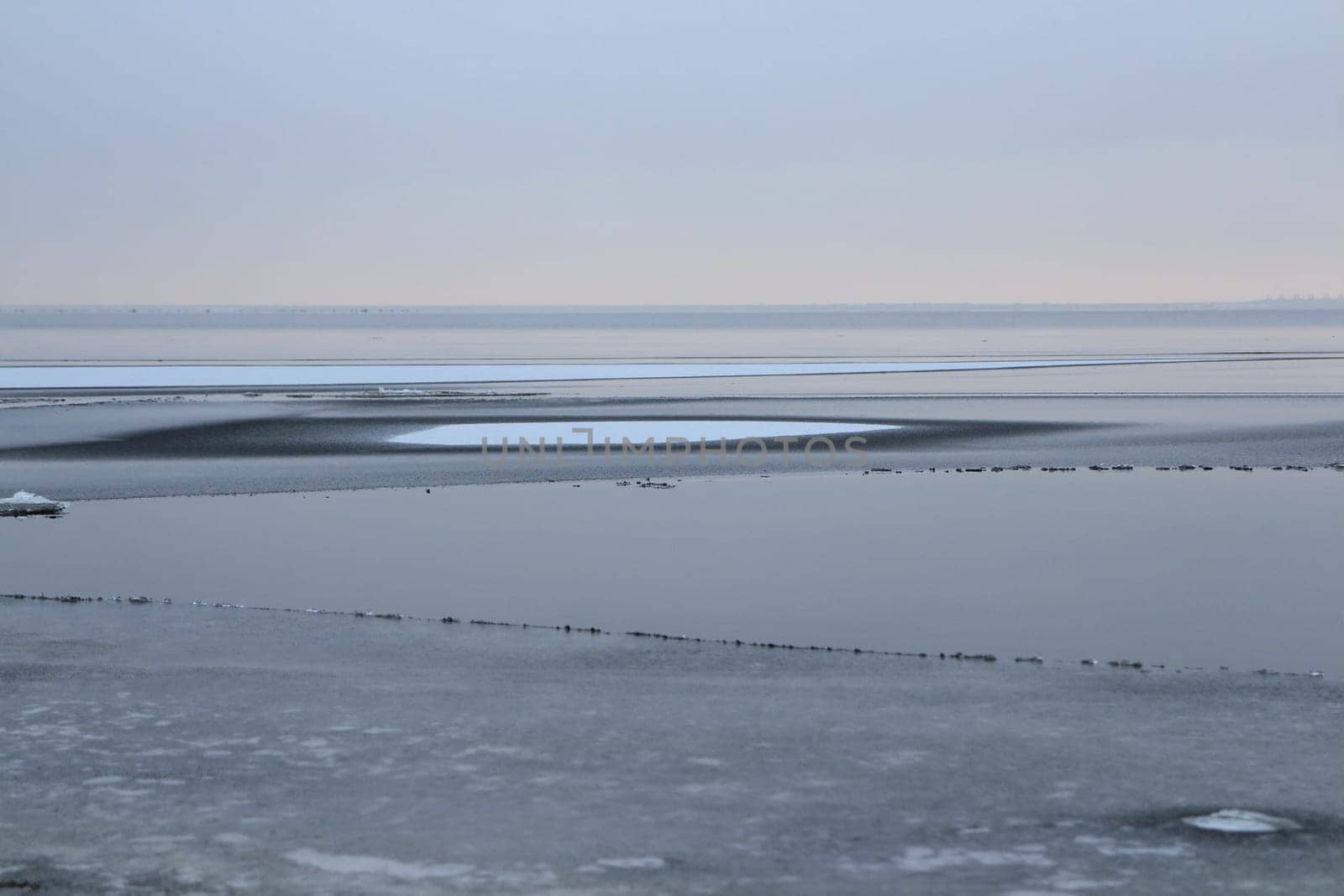 lake is covered with thin ice,  winter landscape