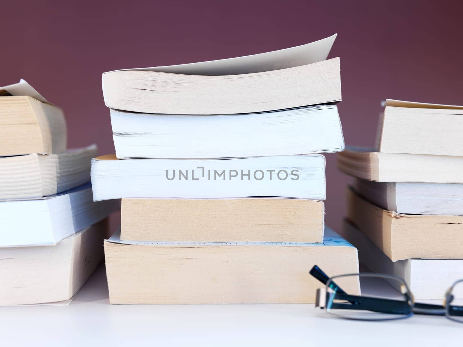 A close up shot of a pile of books