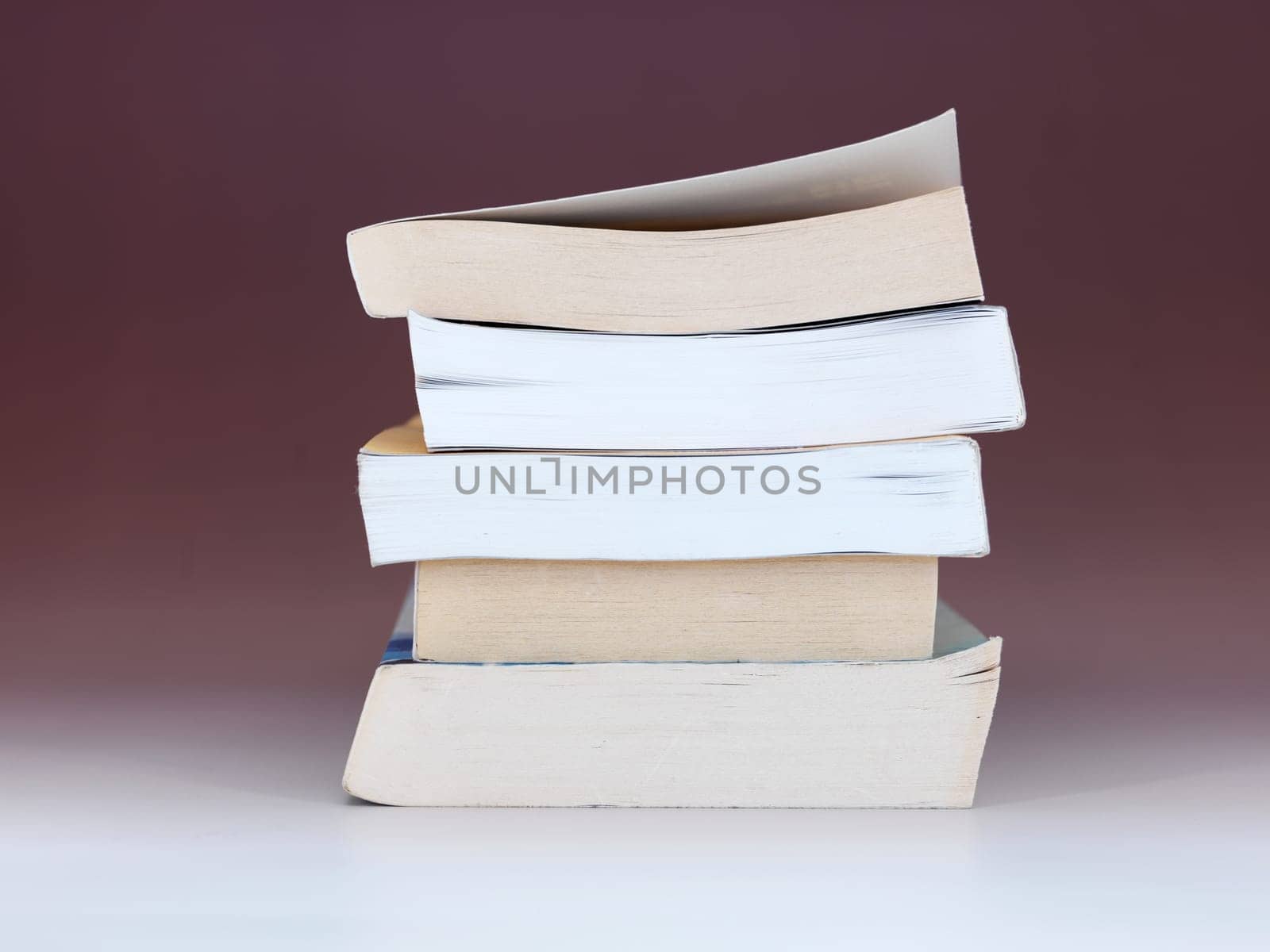 A close up shot of a pile of books