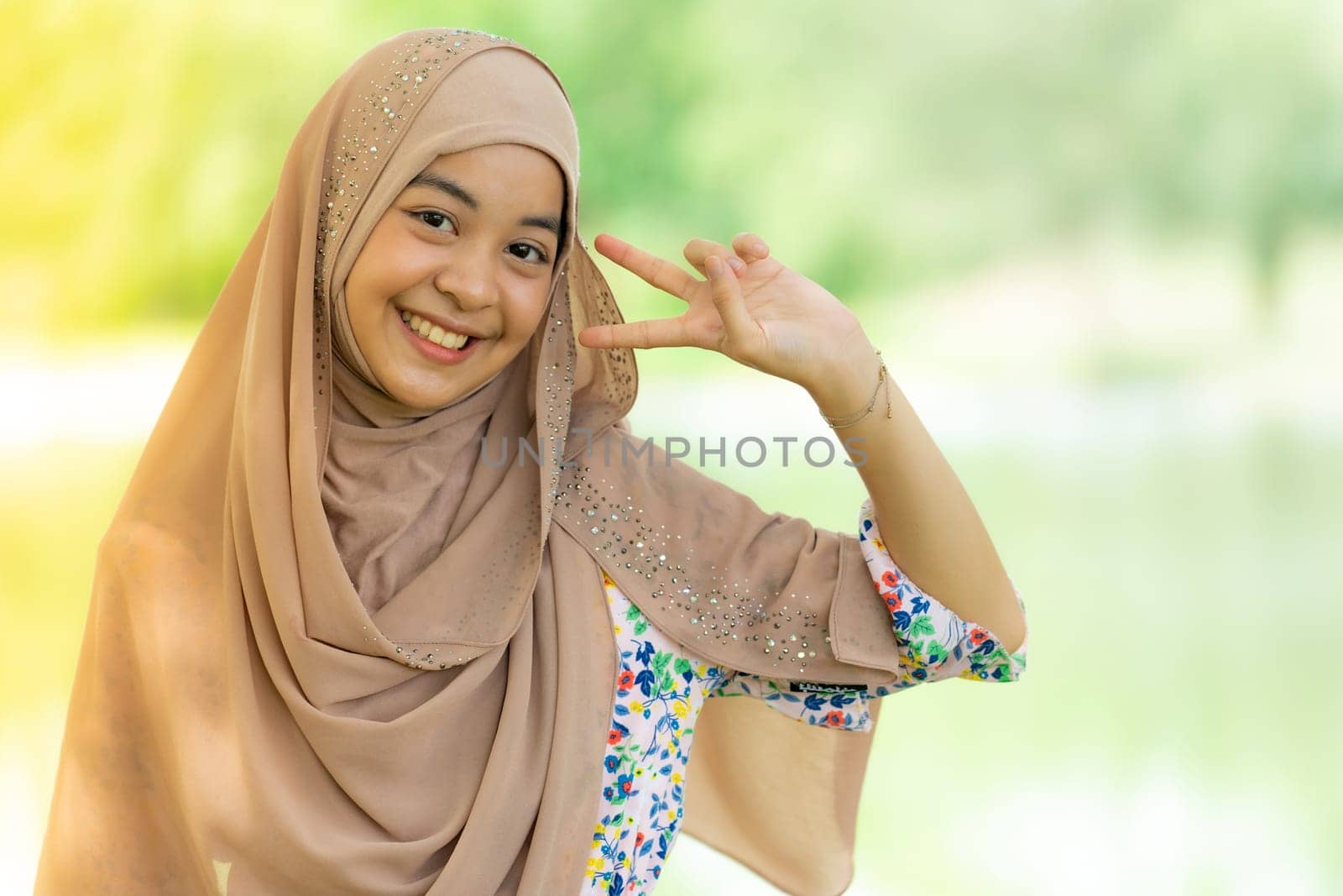 Portrait of good-looking Happy young teenager Muslim islamic asian university girl