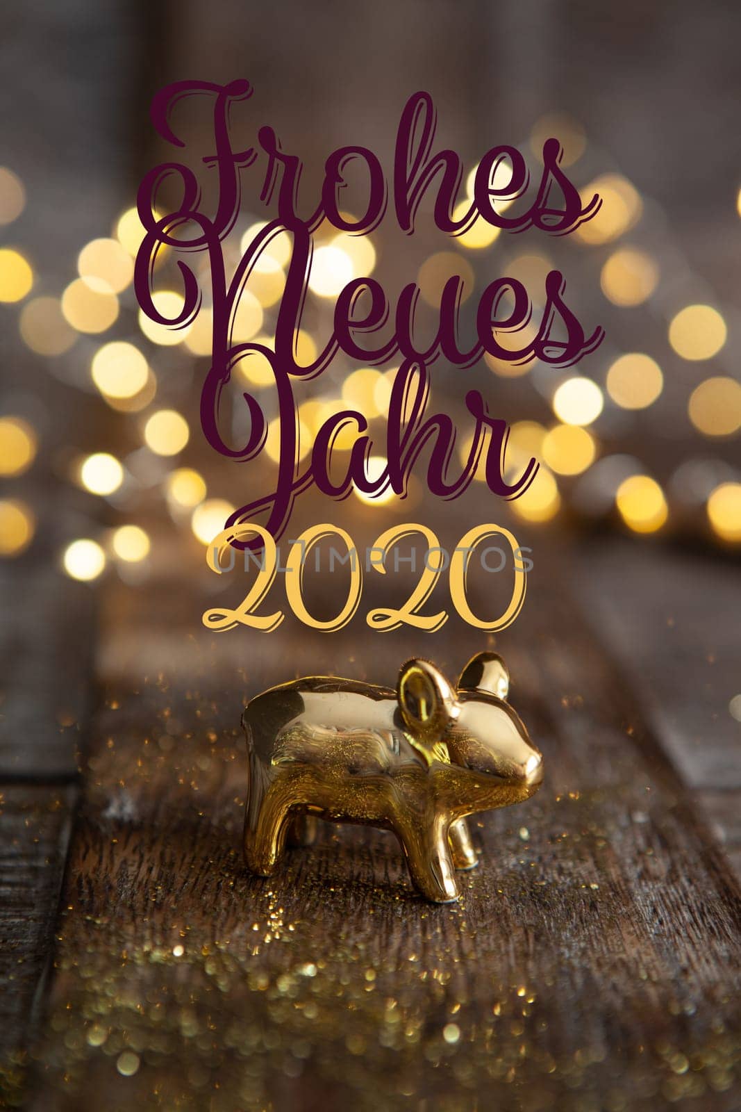 Happy New Year 2020 with a little golden pig in front of Christmas lights