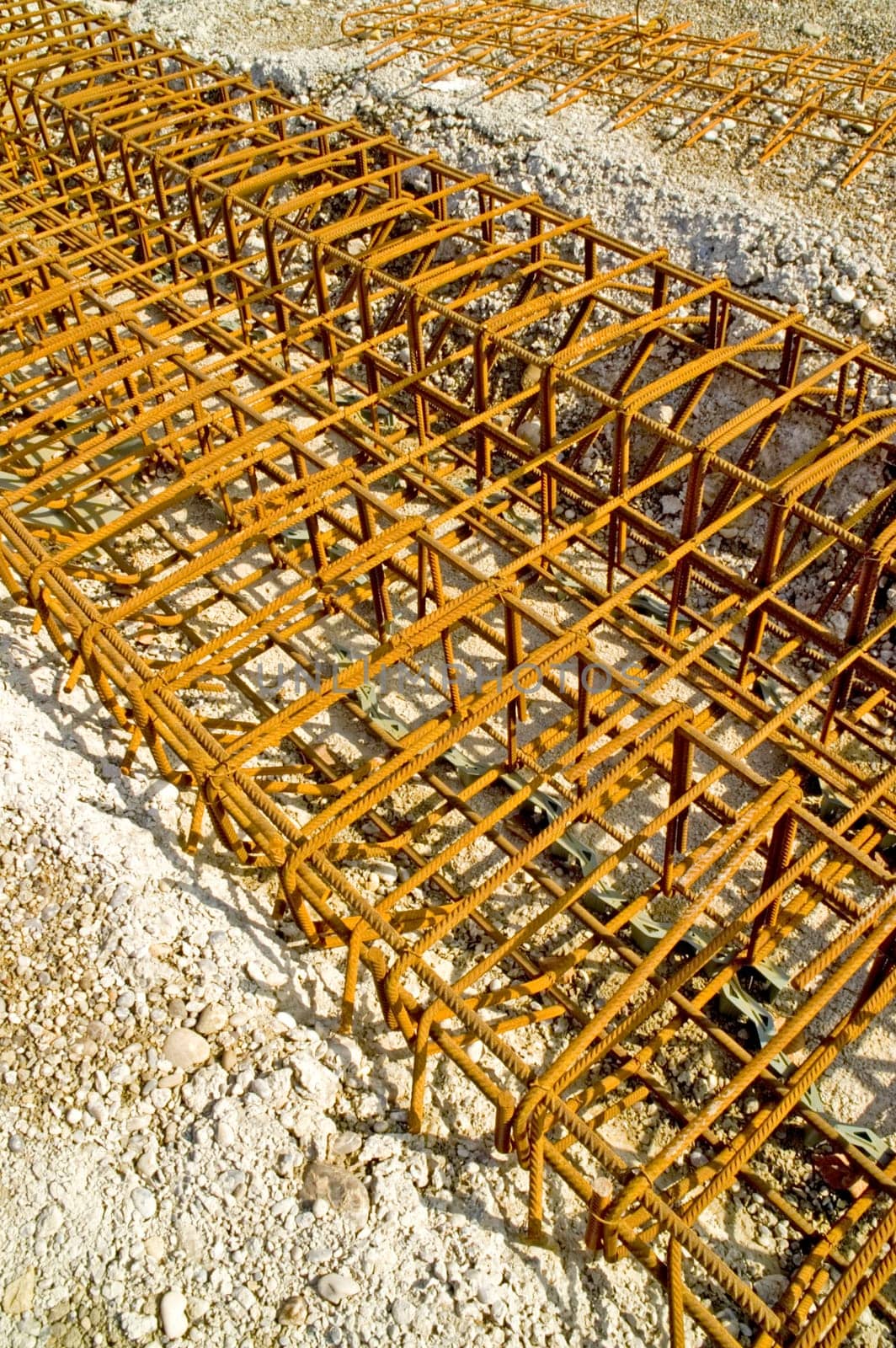 Concrete steel reinforcement partly in concrete. With space for copy.
