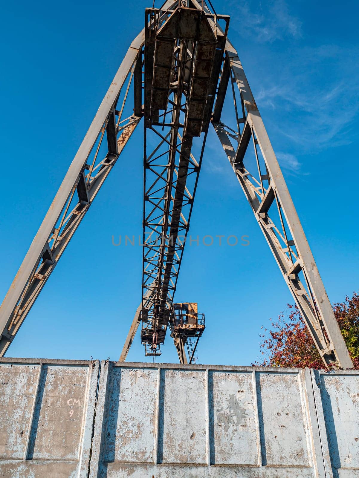 Industrial crane for carrying goods at the factory. Industrial landscape. Place for text.