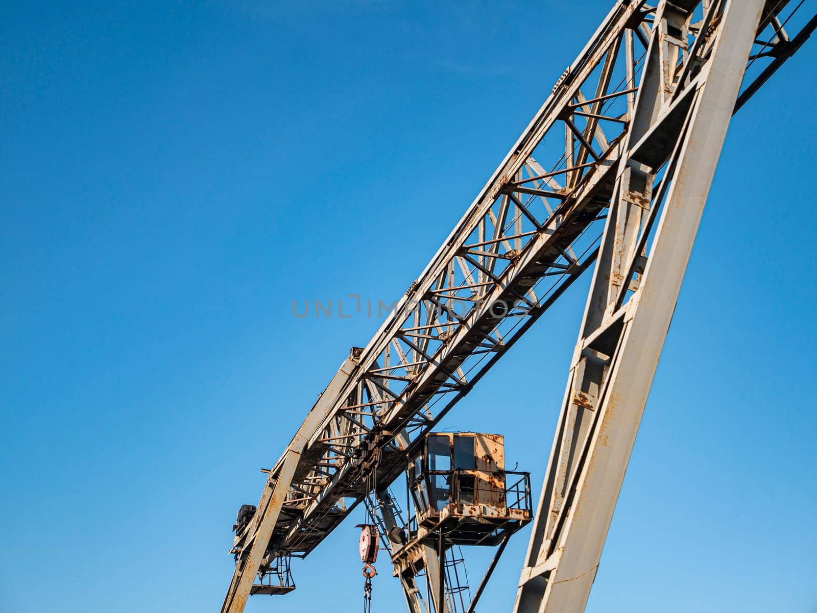 Industrial crane for carrying goods at the factory. Industrial landscape. Place for text.