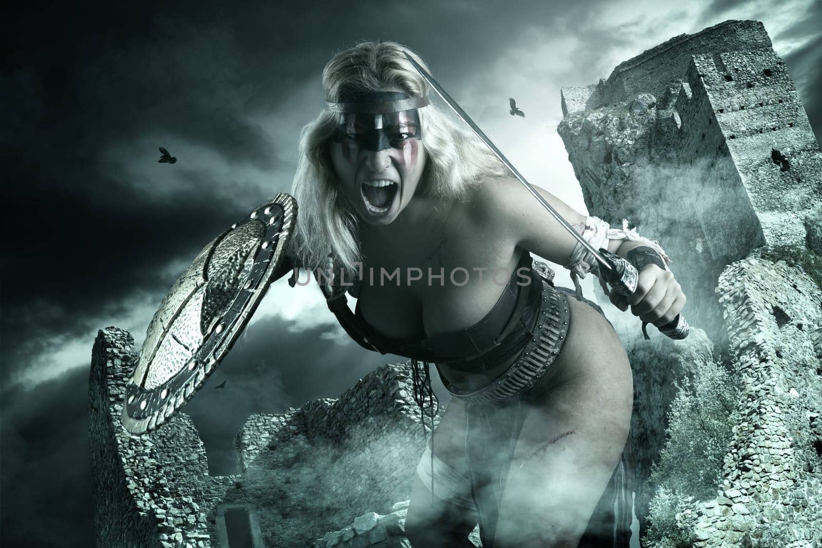 Ancient woman warrior or Gladiator posing outdoors with sword and shield
