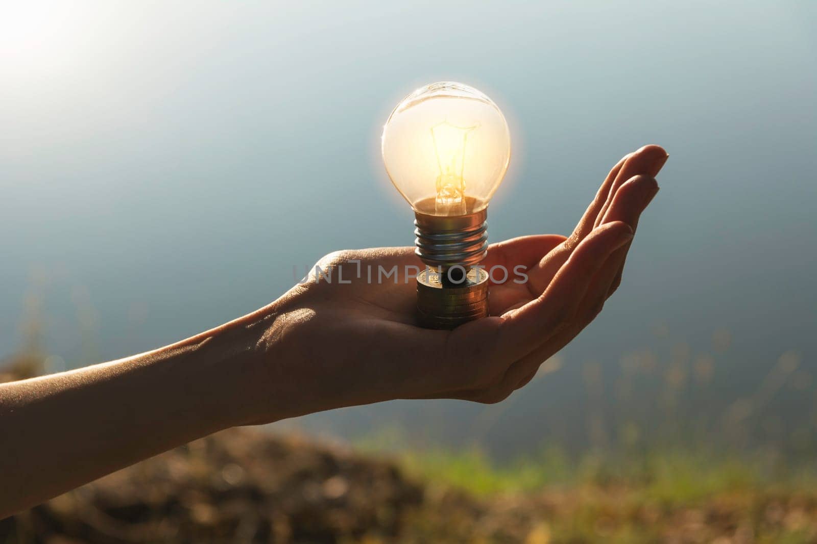 Hand of male holding a light bulb and copy space for accounting, ideas and creative concept.