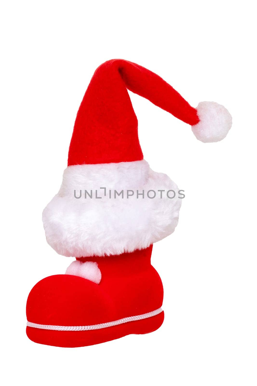 Christmas decorations isolated. Close-up of a red Santa Claus boot with a santa claus hat on it isolated on a white background. Beautiful Christmas design element. Macro.