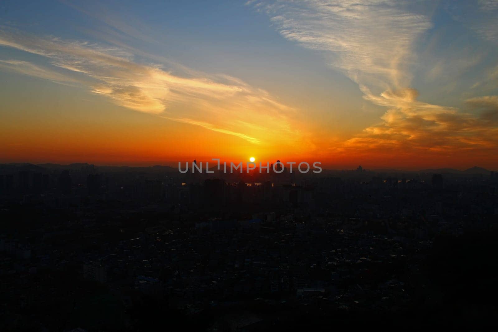 The orange sunset over the city of Seoul