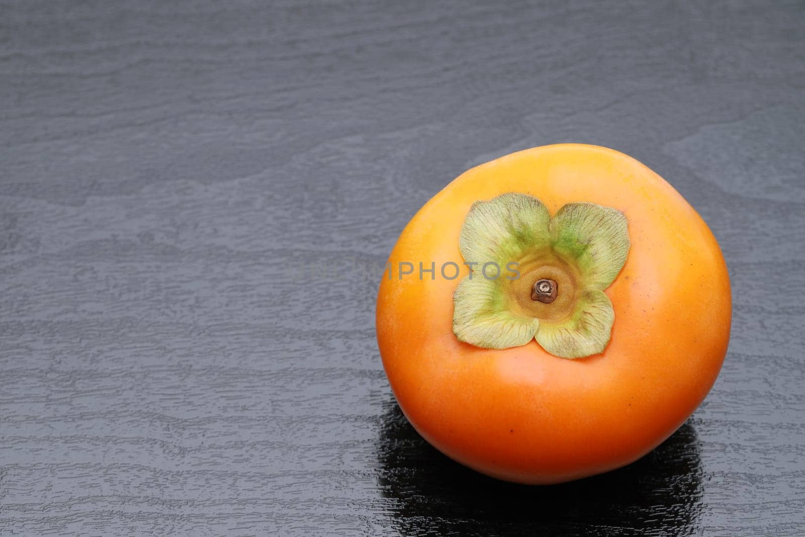 Close up of Persimmon fruit on black background