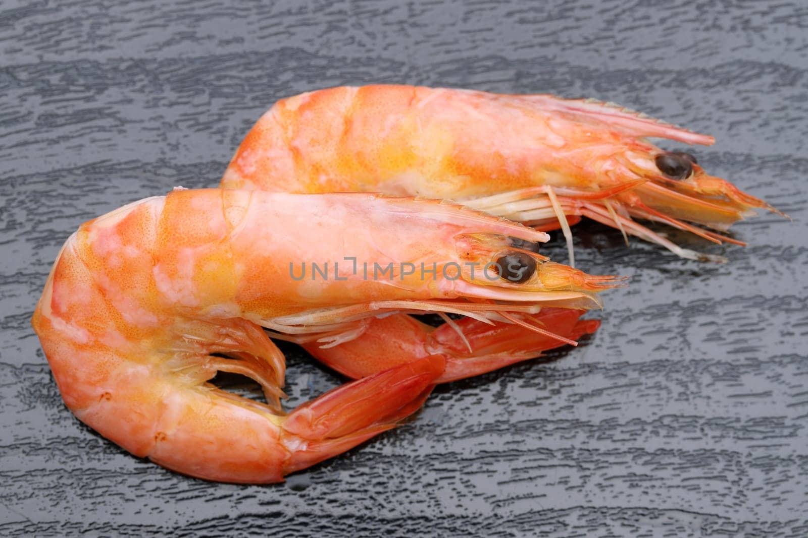 Close uo of red raw shrimps on a black background