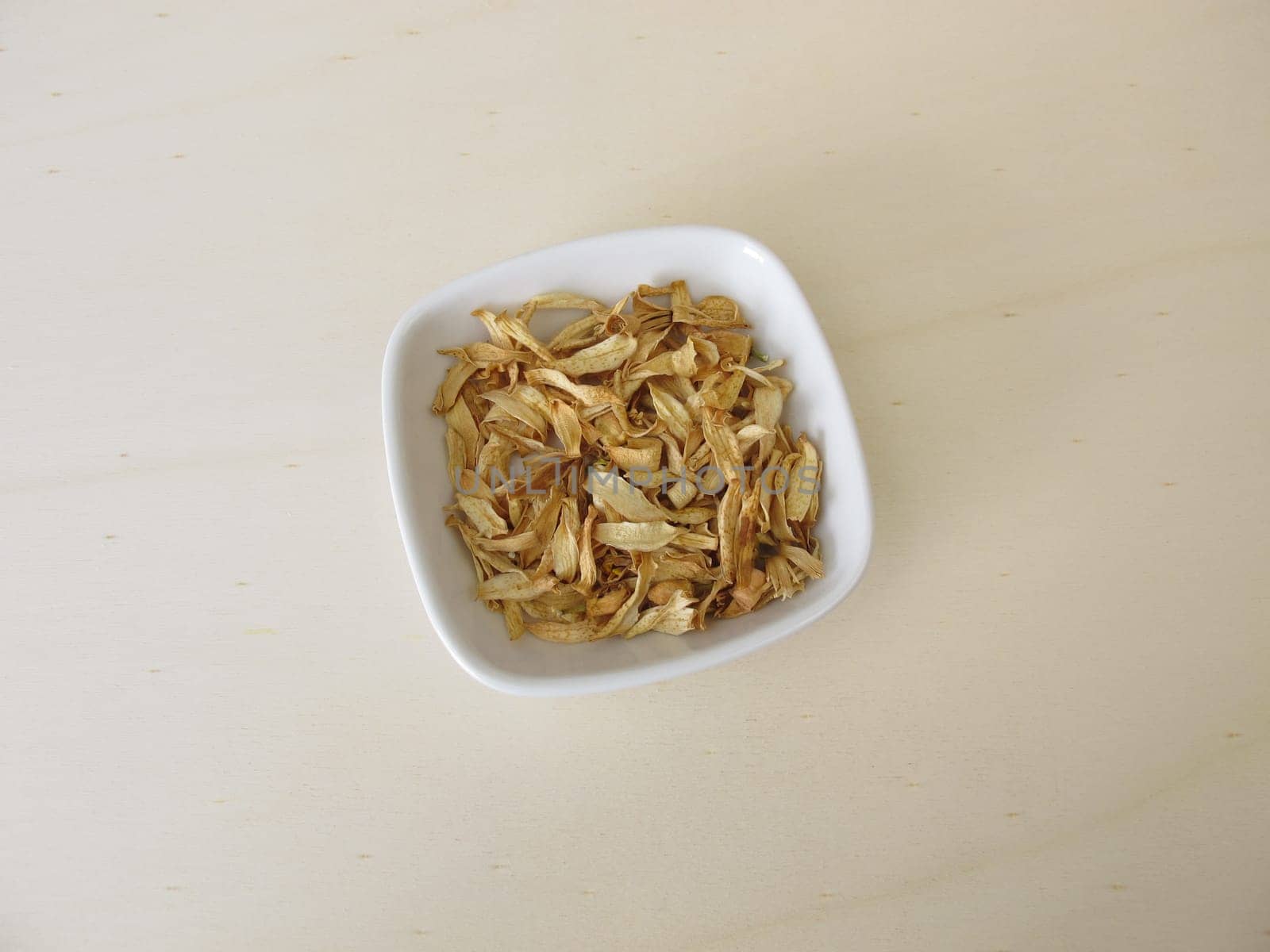 Dried orange blossoms of sweet orange on a wooden board