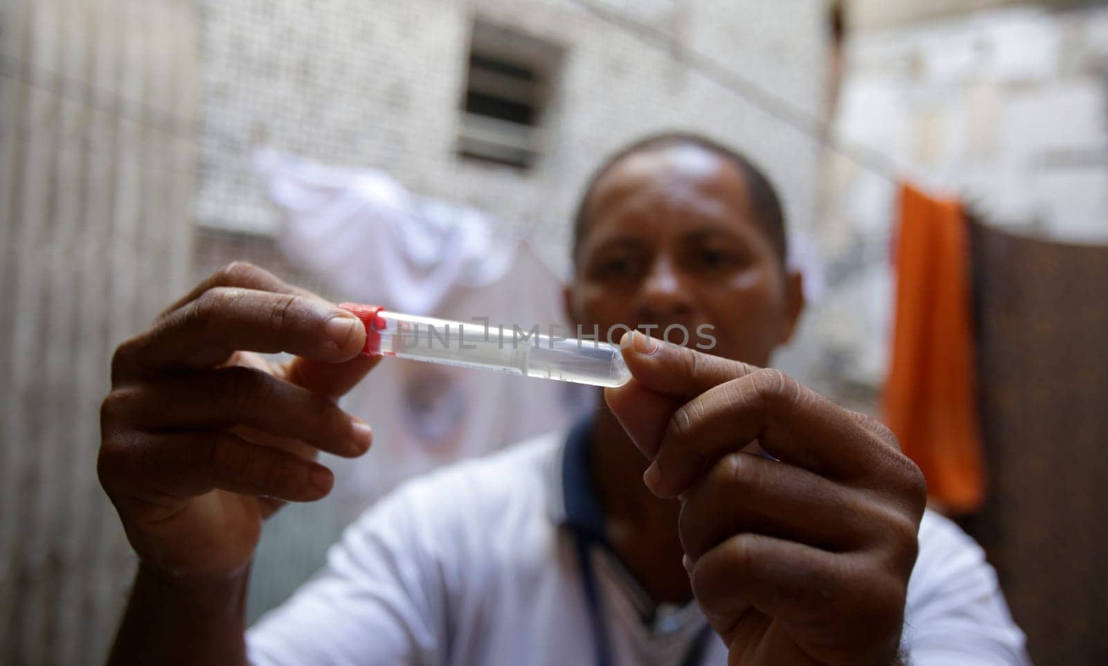 SALVADOR , BAHIA/BRAZIL -  July 5, 2019: Health agent collects sample of Aedes aegypti mosquito larva during a survey of real estate in the neighborhood of Boca do Rio in Salvador (BA).  (Joa Souza / Panthermedia).