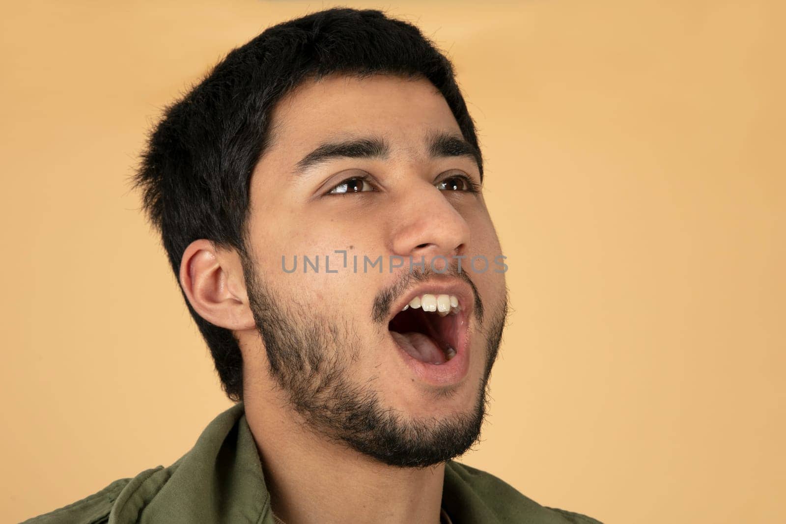 Shouting young Man on beige background
