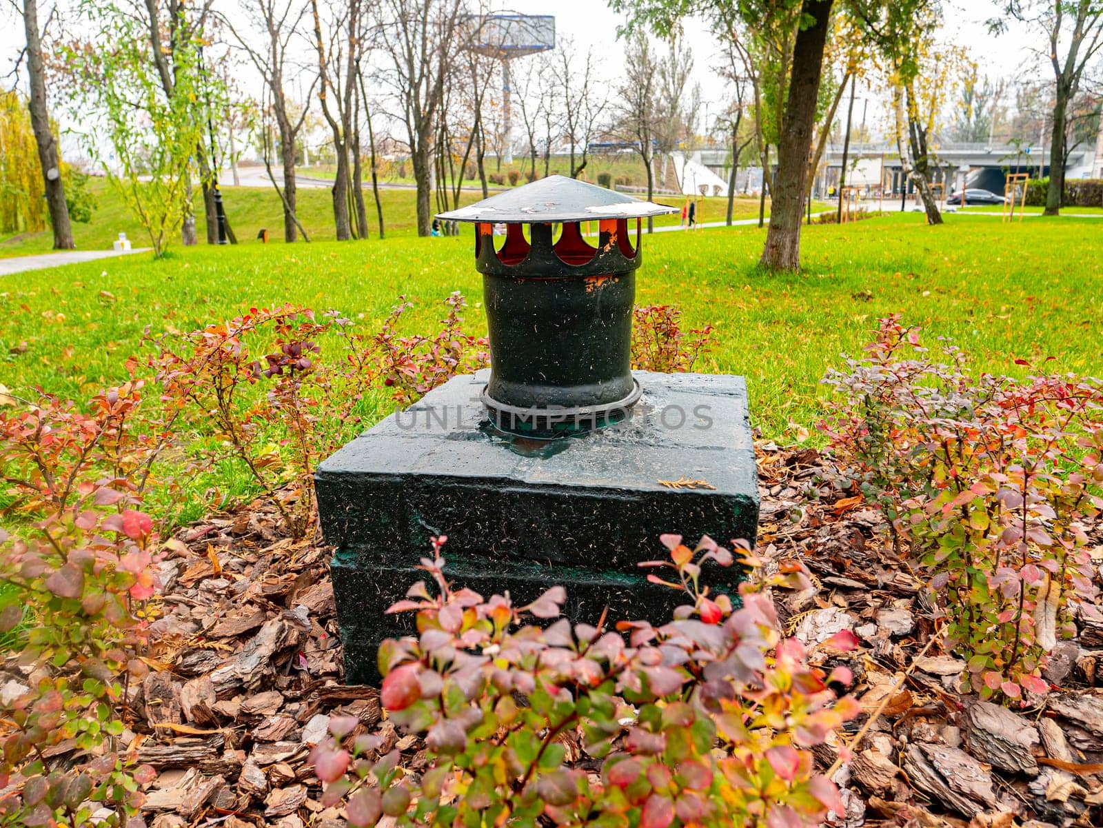Ventilation pipe on the green grass. Industry.