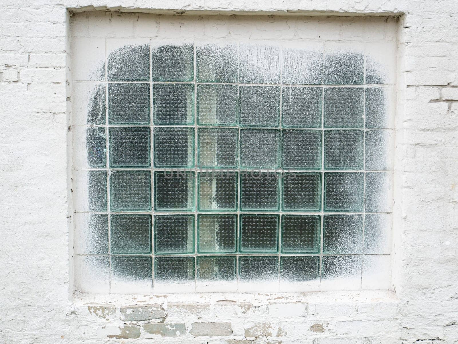 Window with a lattice in a white wall. Place for text. Background image.