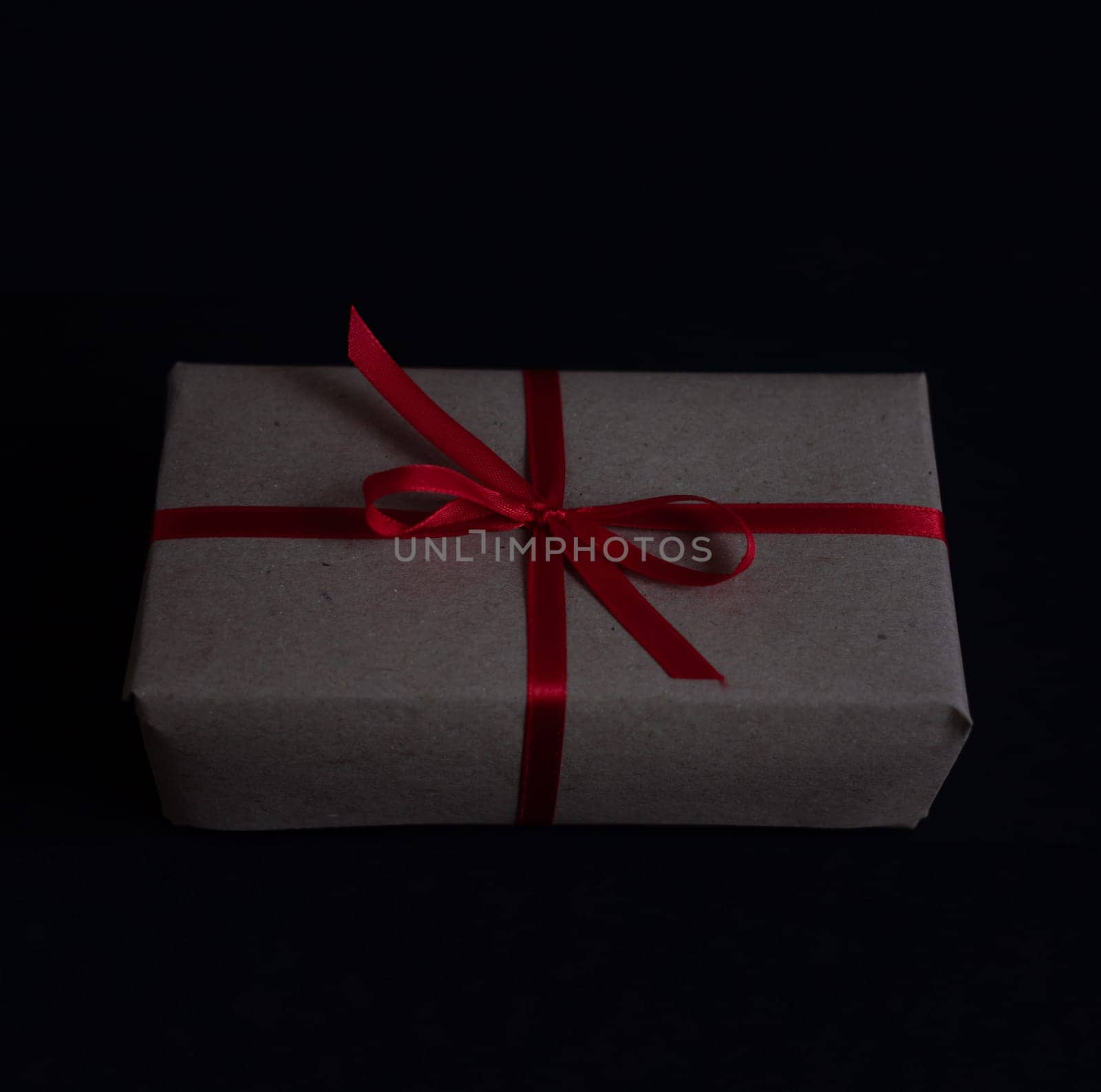 craft gift box with bow knot on dark background