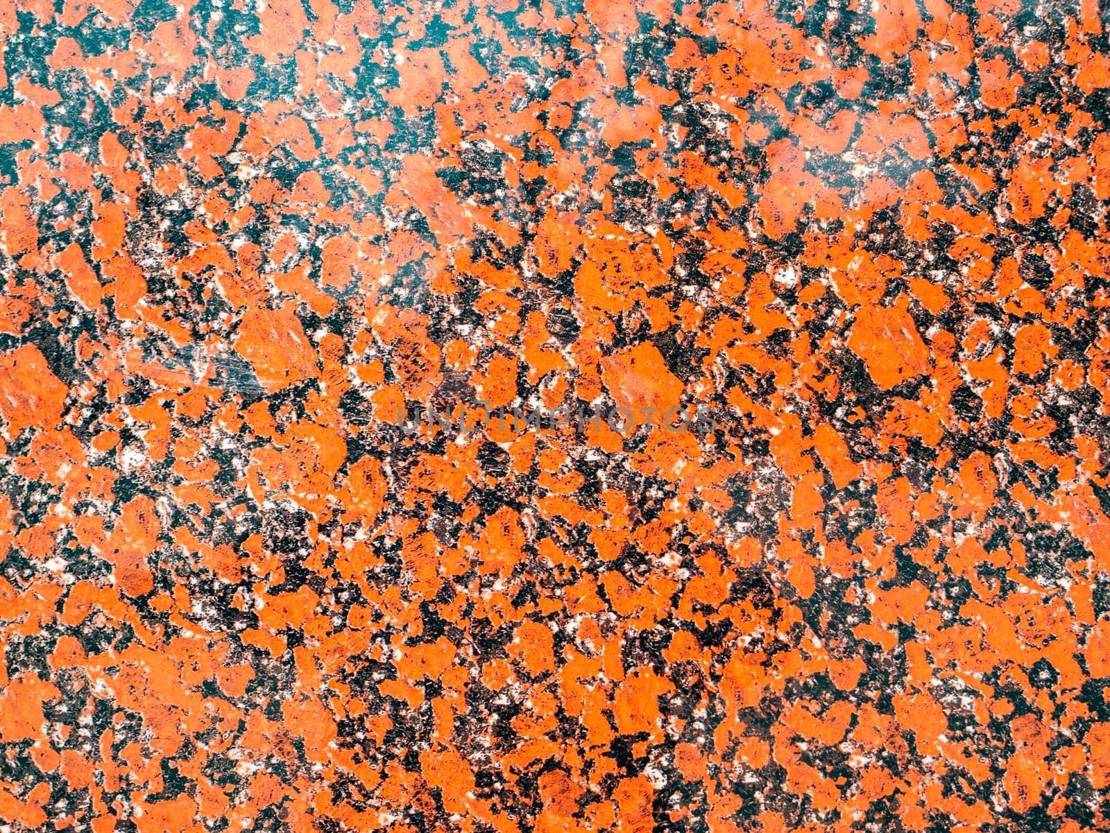 The texture of red granite into black dots. Background. Place for text.