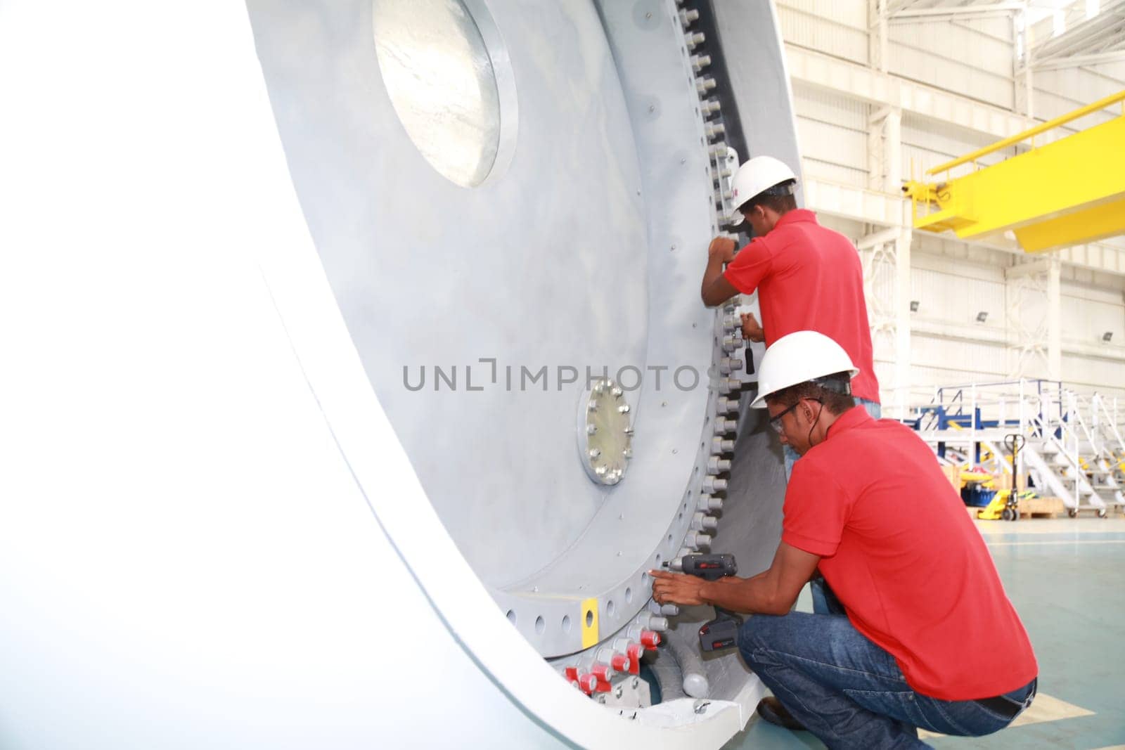SIMOES FILHO, BAHIA / BRAZIL - May 13, 2015: Acciona Windpower wind turbine factory employees are seen working. (Joa Souza / Panthermedia).