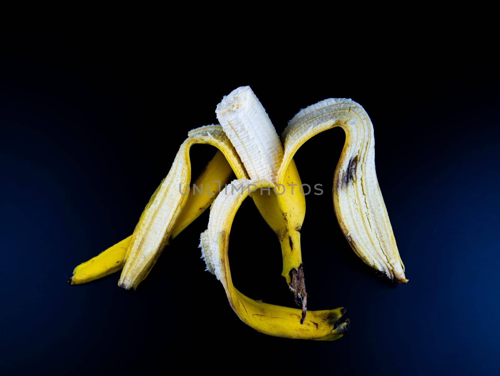Yellow bananas on a black background. Place for text.