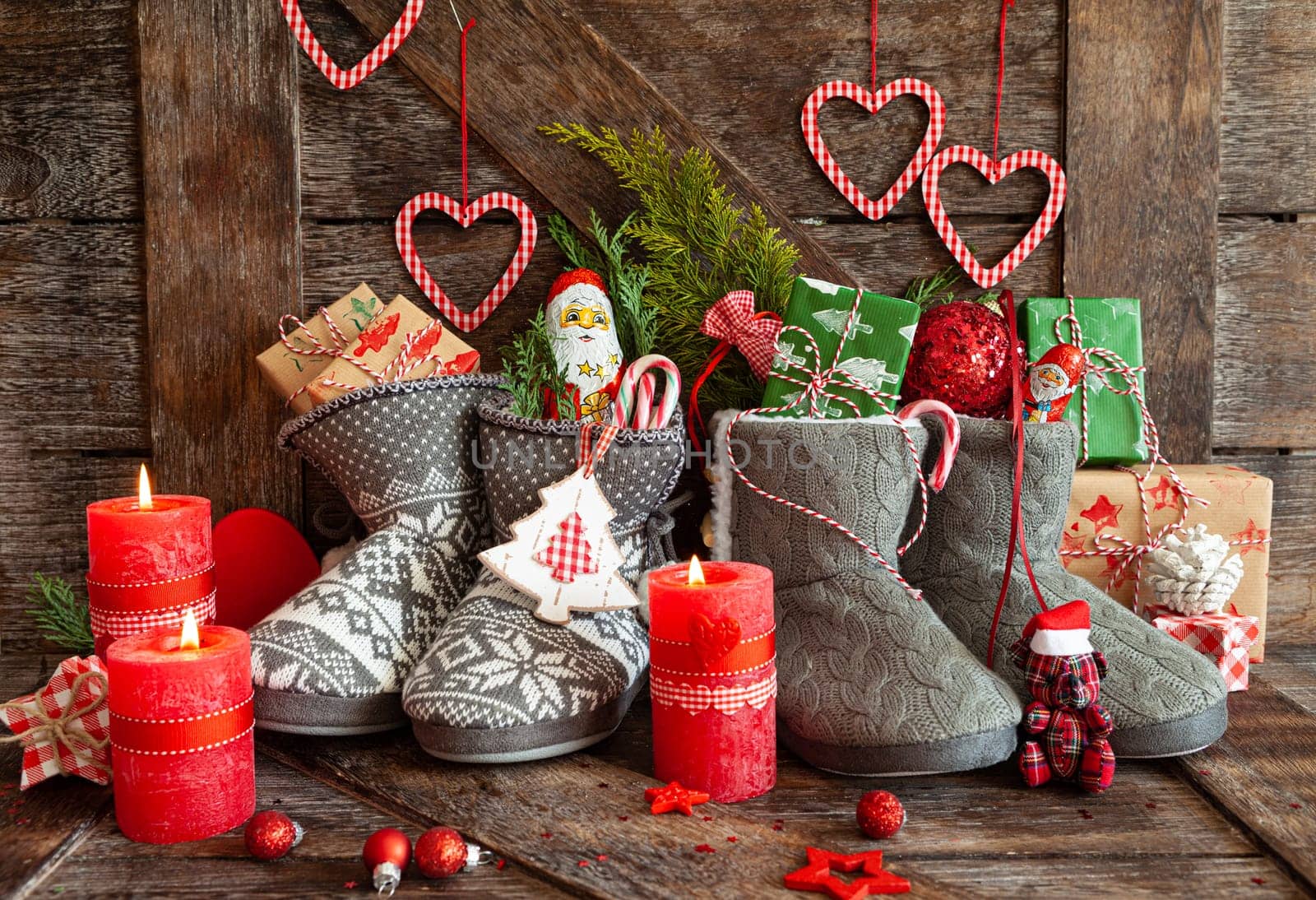 Knitted boots with little presents and candy for Christmas