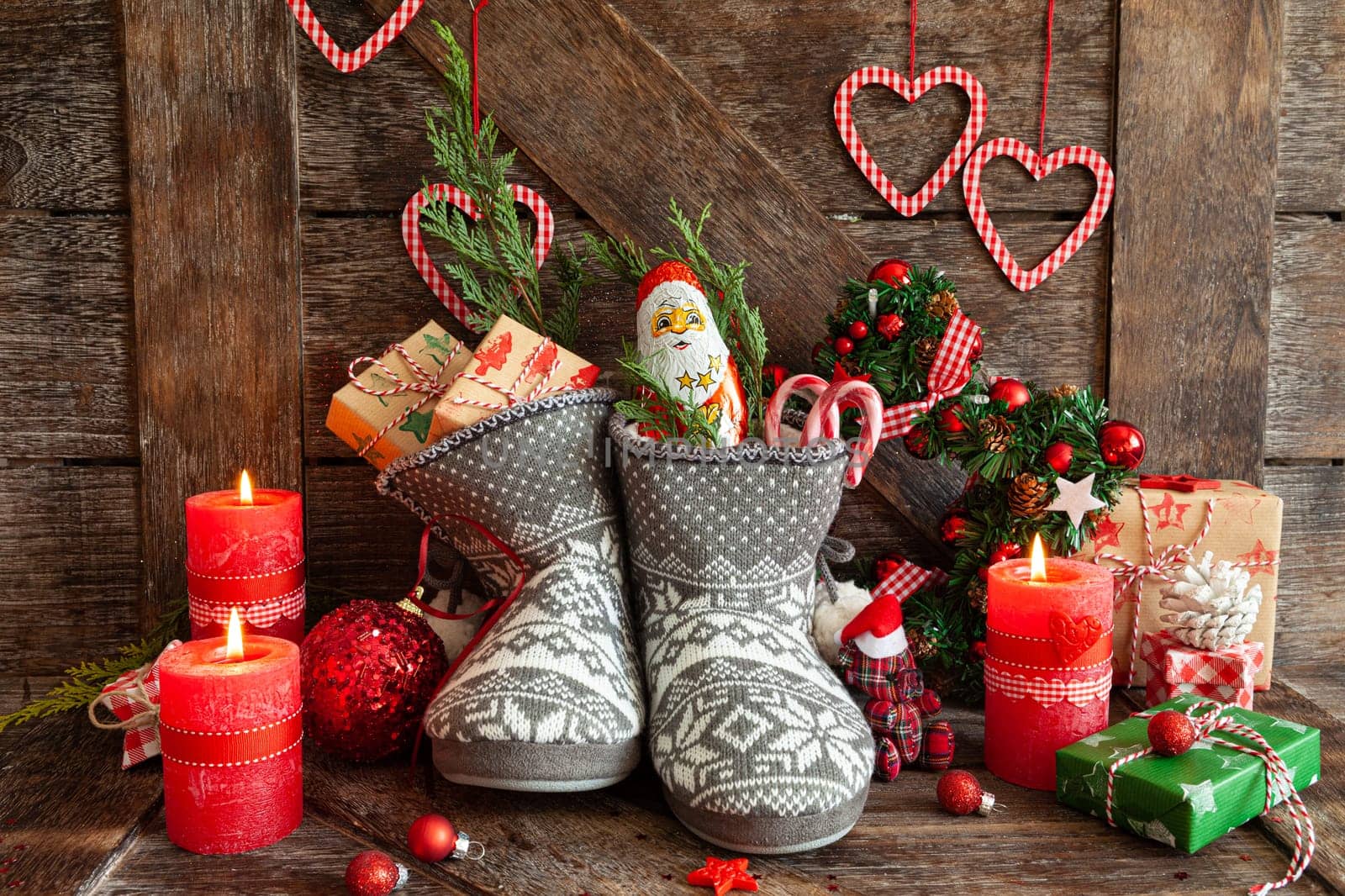 Knitted boots with little presents and candy for Christmas