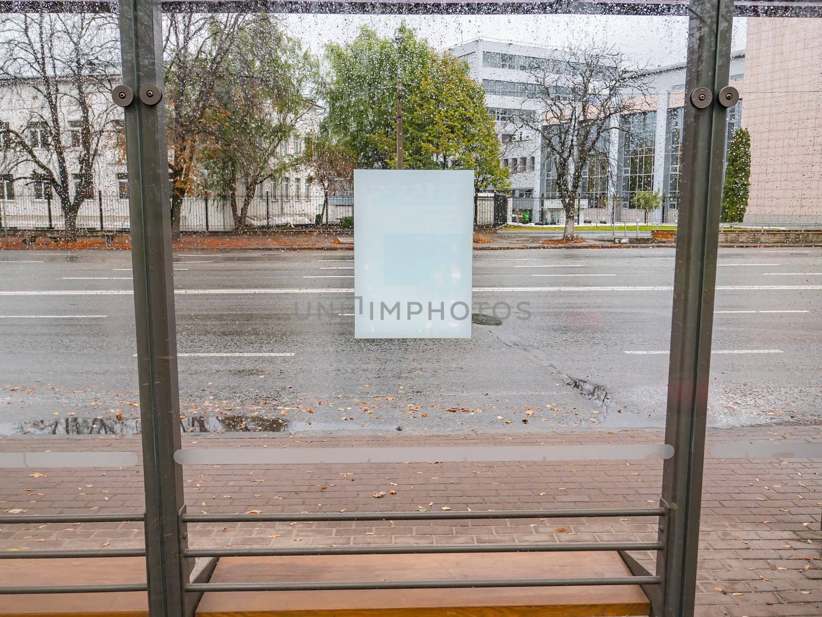 White sheet of paper on wet glass from the rain. Place for text.