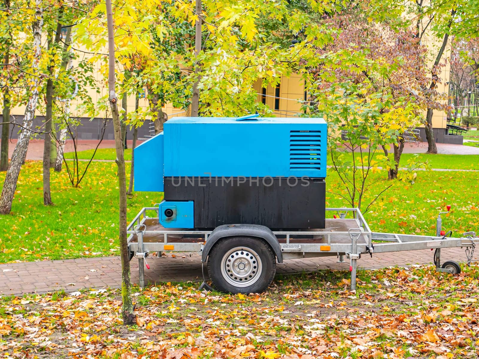 Construction machinery in a public park. Compressor. Place for text.