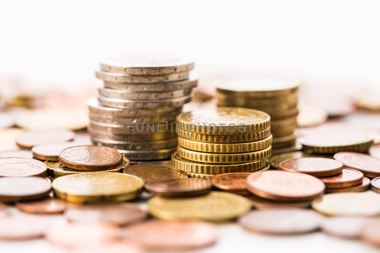 Piles of Euro coins on white background. Money.