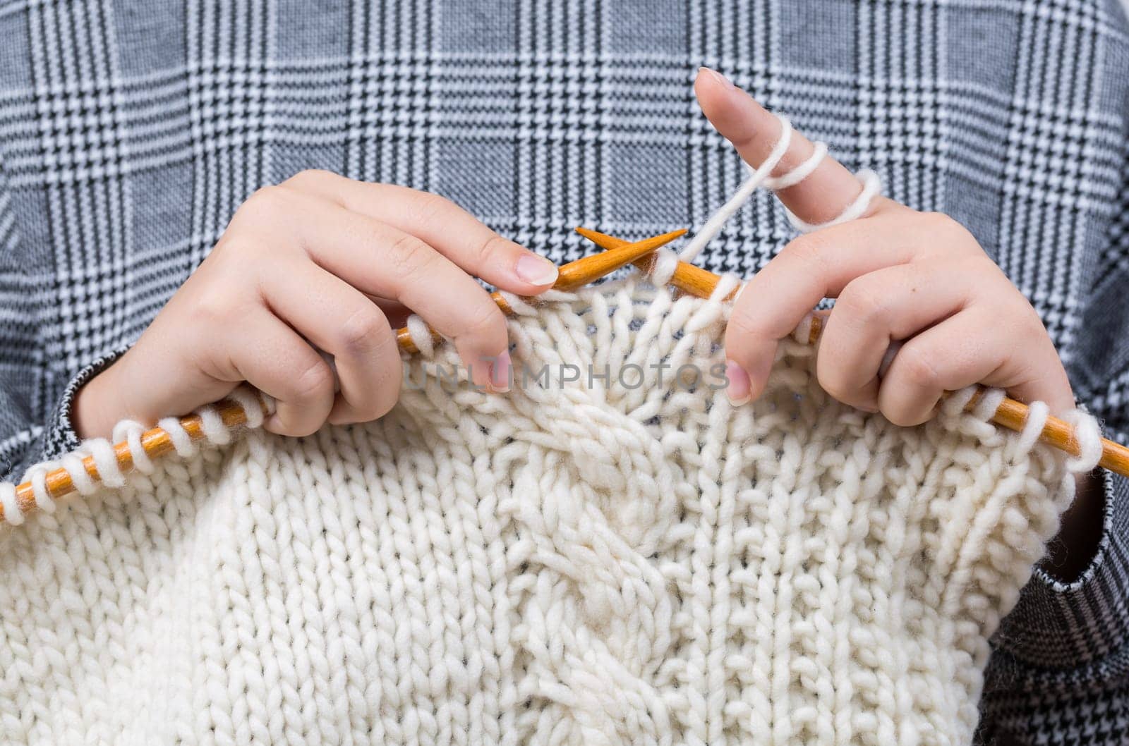 Close up of hands knitting warm sweater